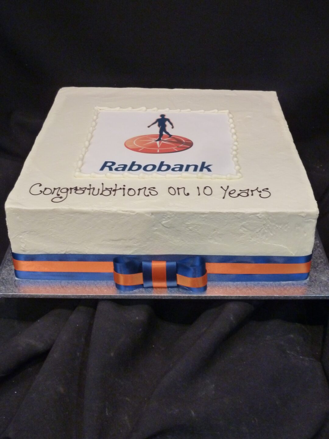 Large: Textured Buttercream with Flat Edible Logo and Ribbon